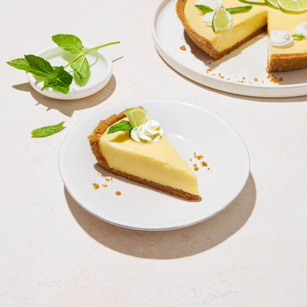 Image of Fireman Derek's Key Lime Pie - Slice of lemon pie accompanied by mint leaves